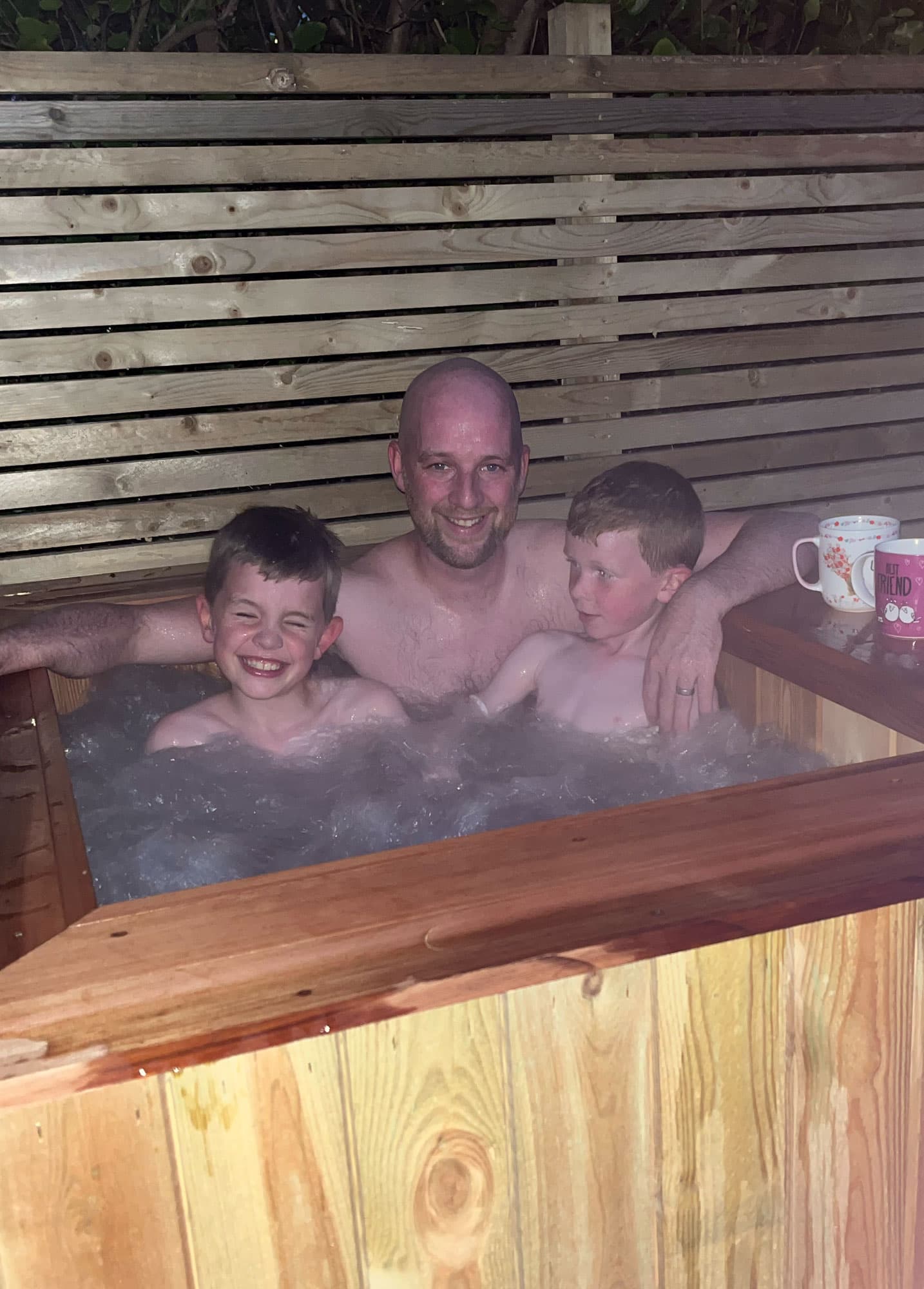 The Manx Quality Sheds family enjoying a hand built garden feature on the Isle of Man