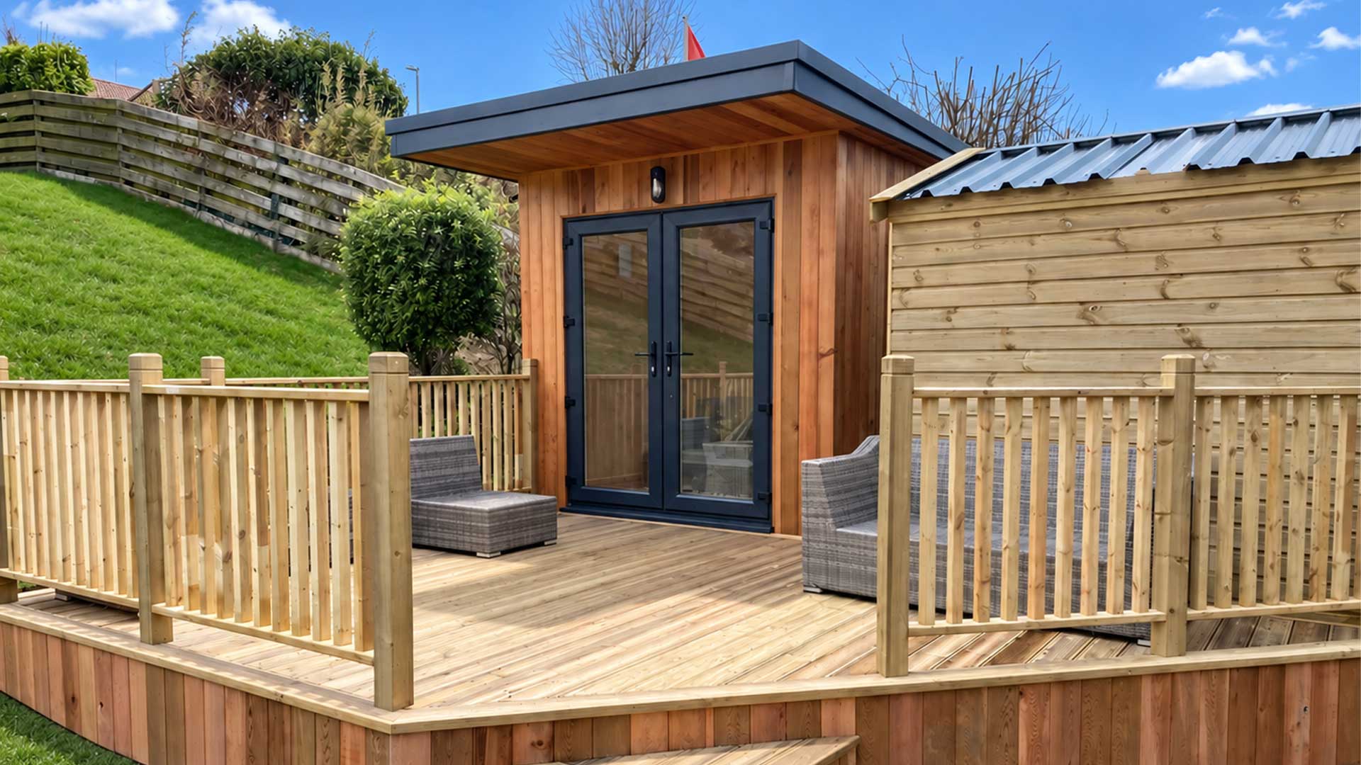 Bespoke cedar-clad garden room with decking, hand built by Manx Quality Sheds on the Isle of Man